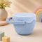 A blue spill-proof baby snack cup featuring dual handles and a flexible top for easy snack access.