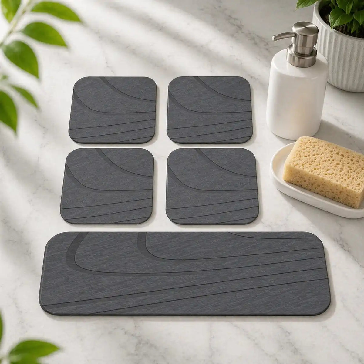 Eco-friendly rectangular grey diatomite drying coaster holding a cold beverage glass with zero condensation water rings on a wooden table.